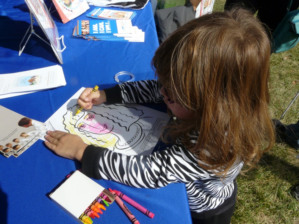 Child coloring at the JNP Event Booth at the National Aquarium